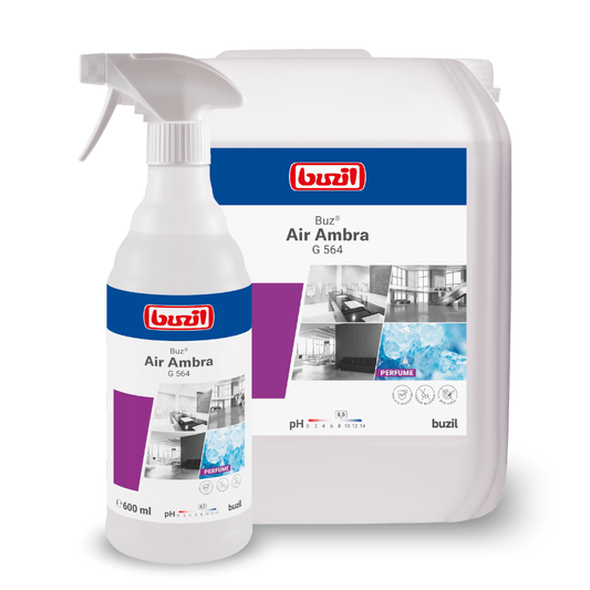 Displayed are two containers with cleaning agents: a spray bottle and a large refill can. Both bear the label "Buzil Buz® Air Ambra G 564 Ready-to-use Room Spray with Active Odor Blocker" from BUZIL-WERK Wagner GmbH & Co. KG, featuring clean rooms and water, as well as an active odor blocker for long-lasting freshness.