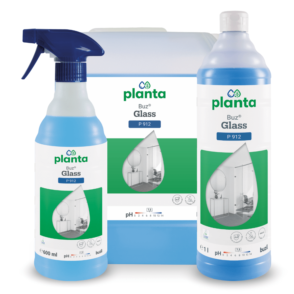 Displayed are three containers of Buzil Planta Buz® Glass P 912 Ecological Glass and Surface Cleaner from BUZIL-WERK Wagner GmbH & Co. KG, including a spray bottle, a large container, and a tall bottle. The green-white labels show an image of a room with a large window and emphasize the environmentally friendly properties.