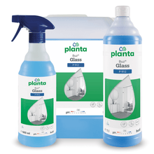 Displayed are three containers of Buzil Planta Buz® Glass P 912 Ecological Glass and Surface Cleaner from BUZIL-WERK Wagner GmbH & Co. KG, including a spray bottle, a large container, and a tall bottle. The green-white labels show an image of a room with a large window and emphasize the environmentally friendly properties.