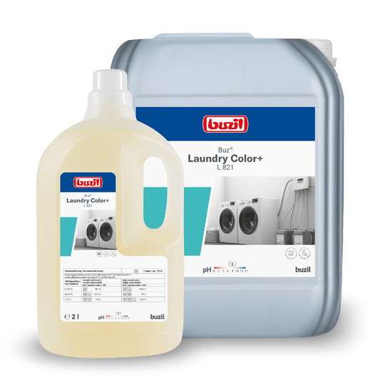 Pictured are two containers with Buzil Buz® liquid detergent. The larger gray container bears the label “Laundry Color+ L 821” from BUZIL-WERK Wagner GmbH & Co. KG and is intended for colored and delicate laundry, while the smaller beige container offers textile care. Both containers feature washing machines and product information on the labels.