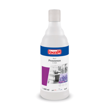 A 600 ml bottle of Buzil Buz® Provence G 565 Ready-to-Use Fragrance Oil with a soothing lavender scent and an active odor blocker. The product label features the brand logo of BUZIL-WERK Wagner GmbH & Co. KG, the product name, and images demonstrating its use. The bottle is designed with a white cap and a predominantly white label, complemented by purple accents.
