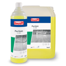 Pictured are two containers of Buzil Perfekt G 440 Alkaline Intensive Power Cleaner Floor Cleaner from BUZIL-WERK Wagner GmbH & Co. KG. The smaller one, a one-liter bottle with a screw cap, and the larger plastic canister are labeled with images from an industrial environment. This cleaner is particularly effective on oil and grease-containing surfaces.