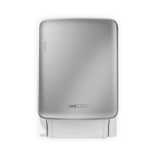 The CWS PureLine Dry from CWS is a silver, wall-mounted dispenser with a small logo near the base. It dispenses individual sheets of white paper towels and promotes hygiene through its simple, sustainable design against a plain background.