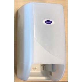 The DI System toilet paper roll dispenser from Diversey Deutschland GmbH & Co. OHG is a white, wall-mounted dispenser with a translucent front cover and an oval label, shown against a light wood background.