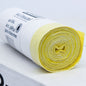 A rolled package of DEISS Trash Bags 56874 30 liters with drawstring from EMIL DEISS KG (GmbH + Co.), with yellow and white plastic trash bags on a white background. The label on the roll shows the dimensions 500 x 600 mm and indicates that it contains 40 pieces with a capacity of 30 liters each.