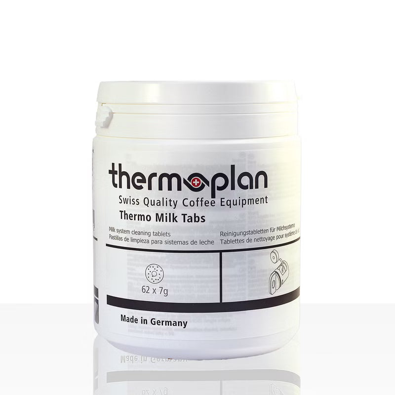 A white plastic container labeled "Thermoplan Thermo Milk Tabs, cleaning tablet for espresso machines | Pack (62 pieces)" from Diversey Deutschland GmbH & Co. OHG, for hygienic cleaning, shows "62 x 7g", "Made in Germany" and multilingual information.