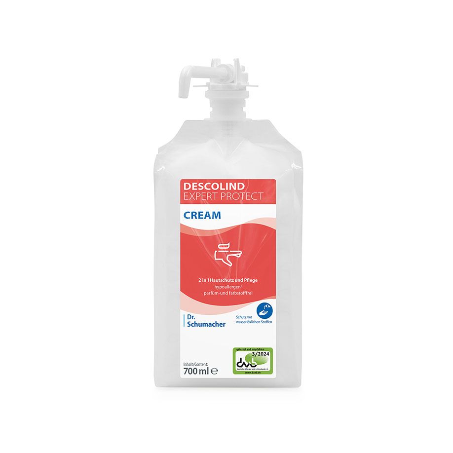 A 700 ml refill pouch of Dr. Schumacher DESCOLIND EXPERT PROTECT CREAM with white tulle and red-white label with product information and blue Dr. Schumacher GmbH branding for professional skin protection.