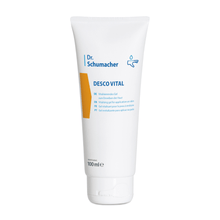 A white 100 ml squeeze tube labeled "Dr. Schumacher Desco Vital Hydro Gel" from Dr. Schumacher GmbH. The tube features a multilingual text that indicates it is a revitalizing hydrogel for application on the skin. The design includes a yellow-orange accent and a simple drop symbol, making it ideal for sports massage.