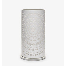 A white cylindrical vase with a modern perforated concentric dot pattern, reminiscent of the elegant Duni candle holder Billy Metal from Duni GmbH, stands against a plain white background.