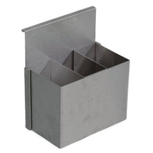 The Novocal stainless steel container (250 x 150 x 300 mm) features three rectangular compartments and a flat back, designed for hanging on a Euro rail in workshops or for attaching to a surface. The package contains 1 piece.