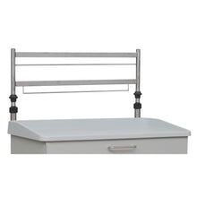 The Novocal Euroschiene 2-fold, a height-adjustable metal frame for rear wall mounting, is mounted above a white cabinet with a handle and raised edge.