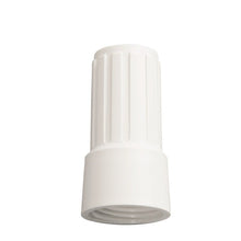 The NUT FOR ADAPTER E1100019 from Haug Bürsten KG is a white plastic connector with vertical grooves, standing upright on a plain white background, ideal for making a robust connection.