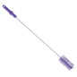 The PIPE BRUSH ø 0.50MM MEDIUM 700Xø60MM from Haug Bürsten KG is a long, narrow brush with a purple plastic handle and cylindrical bristles, ideal for pipe cleaning, pictured on a white background.