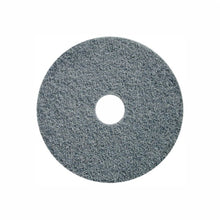 A round, grey Arcora Hi-Pro Agresor | Carton (5 pieces) pad from Arcora International GmbH with a textured surface and center hole, ideal for commercial floor cleaning, is set against a white background.