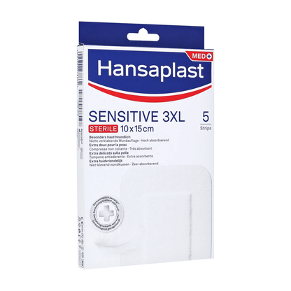 A pack of Hansaplast Sensitive XL, sterile, particularly skin-friendly sterile strips from Beiersdorf AG measuring 10 x 15 cm. The pack contains 5 strips for skin-friendly and highly absorbent wound care. The predominantly white packaging features blue and red accents.
