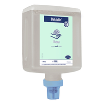 A wall-mounted dispenser bottle with Hartmann Baktolin® Foam hand cleansing foam from Paul Hartmann AG with a blue dispenser nozzle labeled with a fill quantity of 1000 ml hand wash soap. The bottle design includes product information and