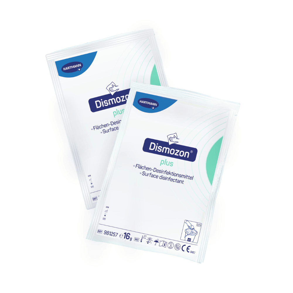 Two packs of Hartmann Dismozon® plus surface disinfectant, each in white packaging with blue and green design, bear the inscription "Surface Disinfectant Cleaner" in German and English. The Paul Hartmann AG logo is located at the top left of each package.