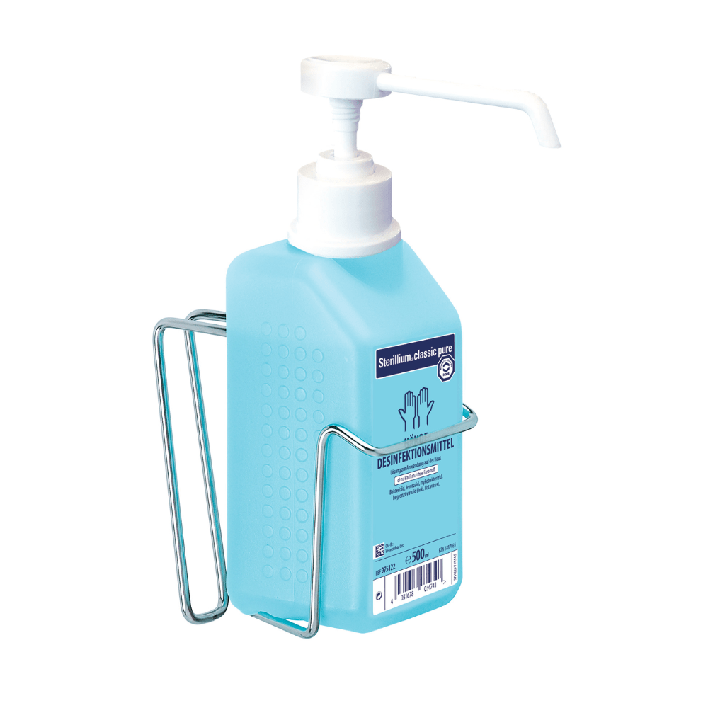 A blue bottle of Sterillium Classic Pure hand disinfectant with a pump dispenser is placed in a metallic Hartmann bottle holder for BODE Eurospender 3 with a curved bracket for 1L bottle | Piece (1 piece) by Paul Hartmann AG. On the front of the bottle, there is a label with text and a hand symbol. It contains 500 ml of disinfectant, perfect for hygiene-sensitive areas.