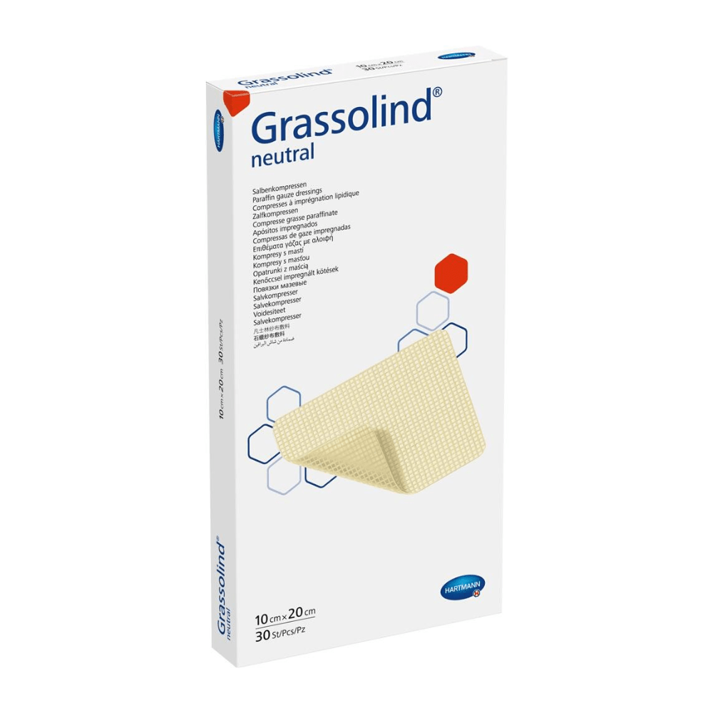 A box of Hartmann Grassolind® ointment compress, various sizes, a medical wound dressing, with important product information and an image of the ointment compress on the front. The packaging is predominantly white.
