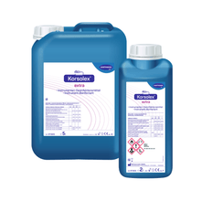 Two containers of Hartmann Korsolex® extra instrument disinfectant from Paul Hartmann AG, one large and one small, blue-white labeled with detailed application and safety instructions.