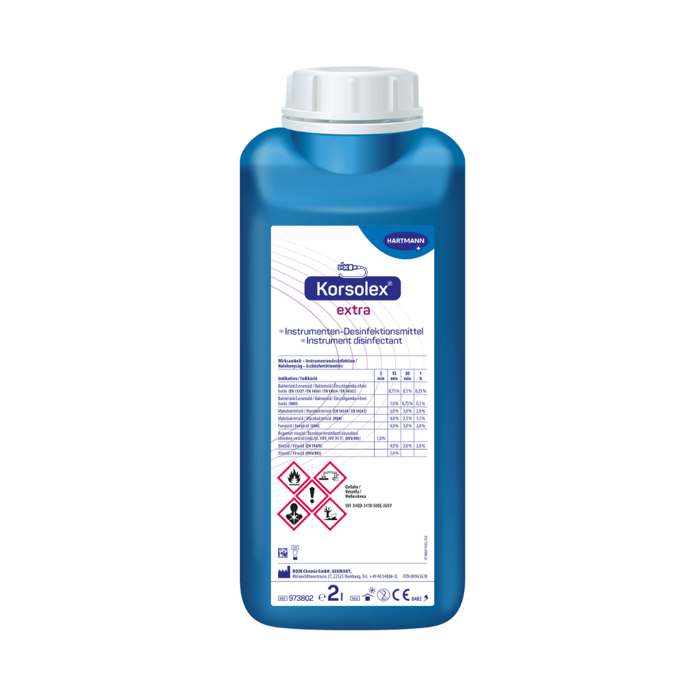 A blue plastic bottle with the inscription "Hartmann Korsolex® extra instrument disinfectant from Paul Hartmann AG", a disinfectant for medical instruments, with hazard symbols and product information on the front label.