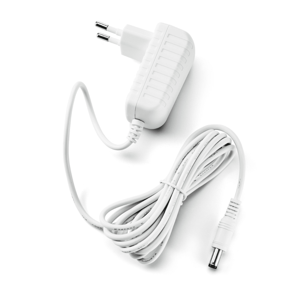 The Paul Hartmann AG Veroval AC/DC Adapter P1 features a white, two-pin plug on the left and a long, coiled cable with a cylindrical connector on the right. Its ribbed sides provide grip and make it ideal for powering devices like the Veroval upper arm blood pressure monitor.