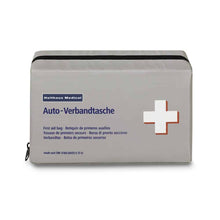 A rectangular, gray first aid bag with a black zipper. The bag bears the text "Holthaus Medical Klassik Verbandtasche", "Auto-Verbands-Tasche" and has a white cross with a red border on the right. At the top, it is labeled with the brand "Holthaus Medical GmbH & Co. KG", which complies with DIN 13164.