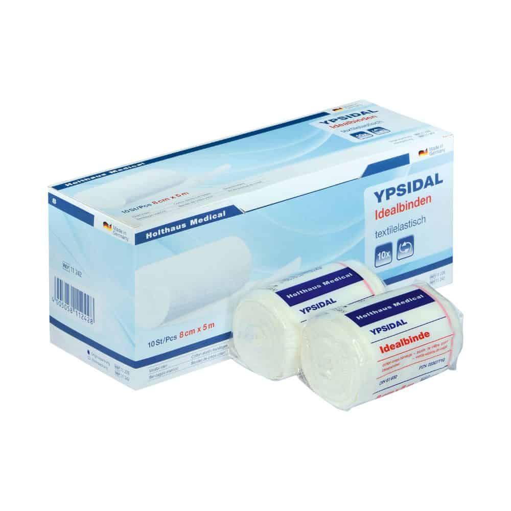 A blue and white box with the inscription "Holthaus Medical YPSIDAL Idealbinde" from Holthaus Medical GmbH & Co. KG with two rolls of elastic bandages on the front. The rolls are wrapped in plastic foil and bear a similar inscription. The packaging contains a German text with the inscription "elastic compression bandage" and images of rolled bandages.