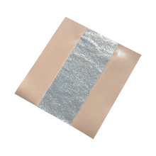A square piece of hypoallergenic Flex-Tape with a central reflective, shiny silver stripe and beige edges on both sides. The tape looks like it is self-adhesive and is folded at one corner, similar to the Holthaus Alumed® wound plaster from Holthaus Medical GmbH & Co. KG (6 cm x 5 m | pack, 1 piece).