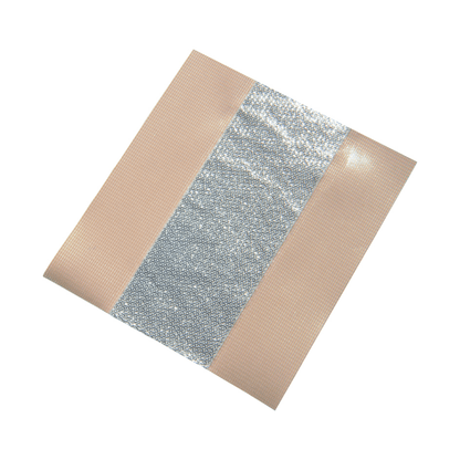 A square piece of hypoallergenic Flex-Tape with a central reflective, shiny silver stripe and beige edges on both sides. The tape looks like it is self-adhesive and is folded at one corner, similar to the Holthaus Alumed® wound plaster from Holthaus Medical GmbH & Co. KG (6 cm x 5 m | pack, 1 piece).
