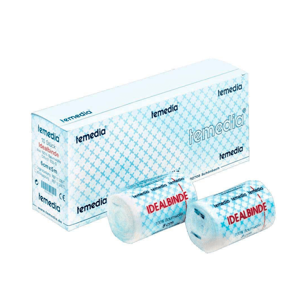 Two rolled bandages with the label "Idealbinde" are displayed in front of a box labeled "Holthaus Temedia®". The box is blue and white patterned and indicates that the elastic bandages are 8 cm x 4 m in size. The product is apparently medical elastic bandages from Holthaus Medical GmbH & Co. KG.