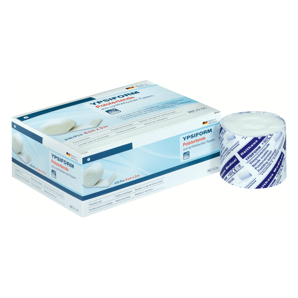 A box of Holthaus Ypsiform padding bandage is pictured next to an unpackaged roll of the bandage. The packaging is predominantly white with blue accents and text, including product details and the trademark of Holthaus Medical GmbH & Co. KG. This high-quality padding bandage offers excellent underpadding for various medical purposes.