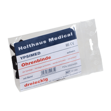 The Holthaus Ypsimed ear bandage from Holthaus Medical GmbH & Co. KG is a packaged ear bandage with the label “Holthaus YPSIMED Ohrenbinde”. The packaging contains a triangular black ear bandage with a band for ear fixation, the PZN number 03024455, and the reference number 50 285.
