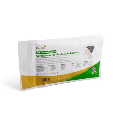 A package labeled „Hotgen Sars-CoV-2 Antigen Layman's Rapid Test CE0123 | Package (1 Test)“ for self-testing features green and orange accents and shows an image of a person. The „Hotgen“ logo is clearly visible in the upper left corner and identifies the test as a SARS-CoV-2 antigen test.