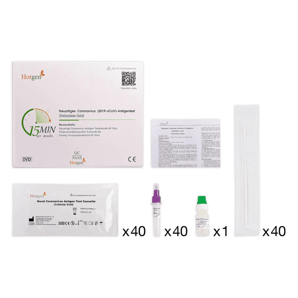 The image shows a carefully arranged Hotgen Antigen Rapid Test (Colloidal Gold) Professional Approval Covid-19 Antigen Test Kit, consisting of a labeled box, an instruction sheet, and the Hotgen brand 2019-nCoV antigen test cassette pack. The set includes 40 test cassettes, 40 sample collection vials, a swab, and 40 caps.