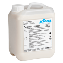 A 5-liter bottle of Johannes Kiehl KG Ceradur-compact, a metal salt-free care dispersion for highly absorbent floor coverings, comes in white plastic with a handle and a German label. Sold in a box with 2 bottles.