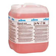 A large, transparent plastic container with pink liquid is labeled "Kiehl Duocit-eco sanitary cleaner with orange freshness" by Johannes Kiehl KG and on the front, product information and eco-friendly cleaning tips in German.