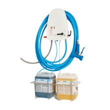 The Johannes Kiehl KG ARCANTEC 15 cleaning and disinfection unit for 2 products is wall-mounted, features a 15 m long blue hose with spray gun, and holds two labeled chemical containers in metal racks against a white background.
