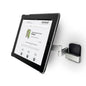 A Novocal tablet holder variant 1 (for tablets 7-12 inches, swivel up to 180°) is mounted on a silver wall bracket with a swivel arm; on the tablet, a website with "novocal" as the heading can be seen.
