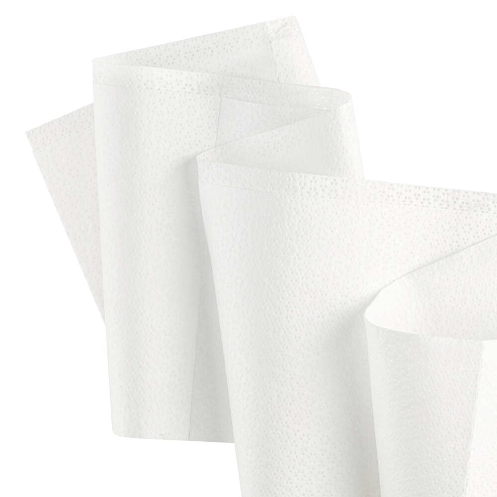 Two folded white Kimtech® Wettask™ DS Wipes from Kimberly-Clark GmbH in front of a plain background show their dotted texture and versatility; pictured here as small rolls (12 x 55 sheets) in a box.