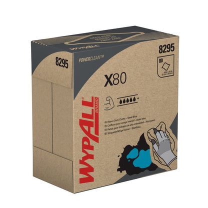 A pull-up box labeled WypAll® X80 PowerClean from Kimberly-Clark GmbH contains 80 steel blue cloths with application instructions and a hand depicted on the box for wiping up a blue stain. Available as 5 boxes per carton (5 x 80 sheets).