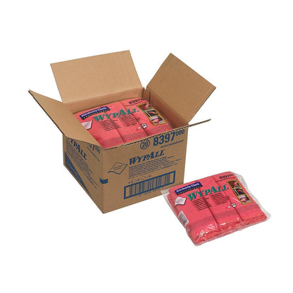 An open box from Kimberly-Clark GmbH labeled "WypAll" contains several packs of WypAll® microfiber cloths - flat cloth, 40 x 40 cm. Each pack contains red microfiber cloths; one pack of flat cloth is outside the box.