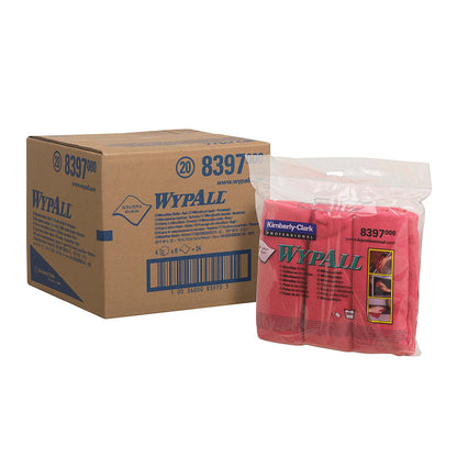 A cardboard box labeled "WypAll" stands next to a transparent plastic package with red WypAll® microfiber cloths - flat cloth (40 x 40 cm) by Kimberly-Clark GmbH, featuring cleaning instructions and images printed on it.