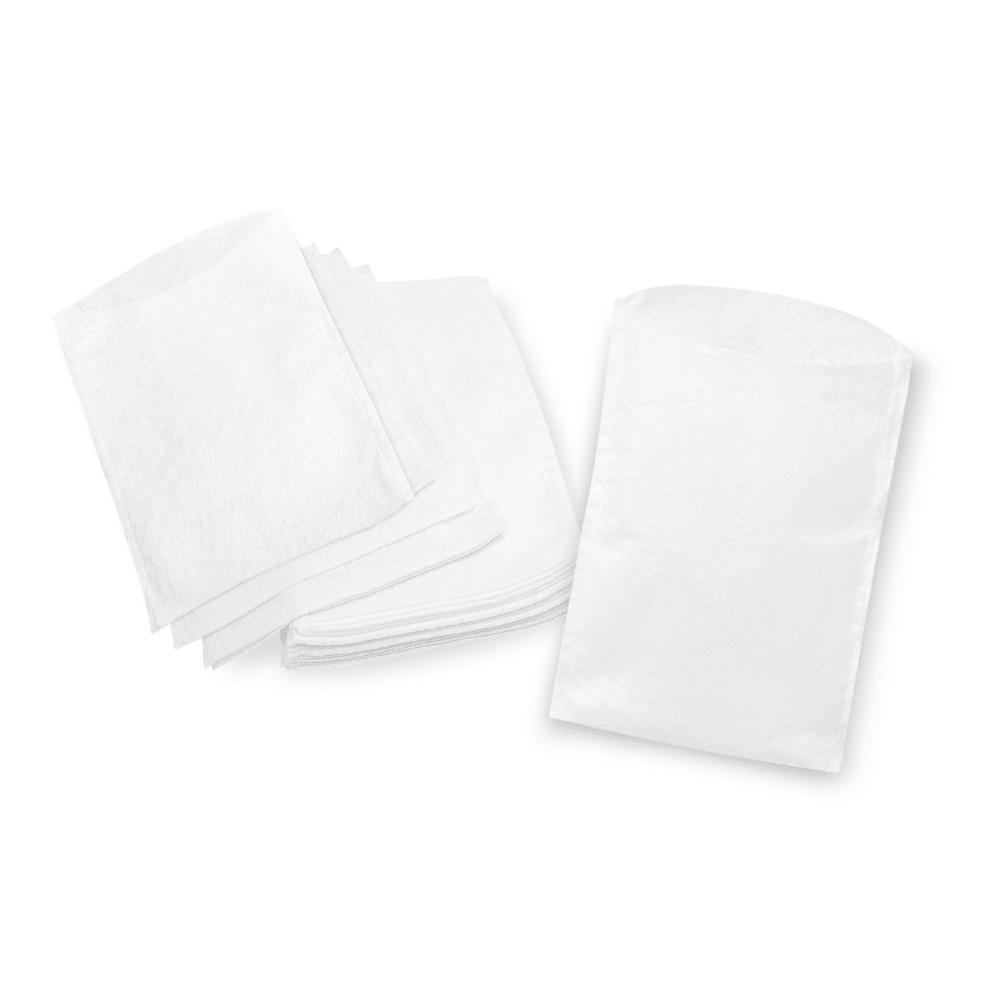 A stack of neatly folded white paper napkins next to a stack of unfolded Meditrade disposable wash gloves, all placed on a white background.