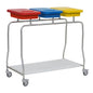 The Novocal stainless steel waste collector "Compact" triple collector features a stainless steel frame, three color-coded lids (red, blue, yellow), a lower white insert shelf, and four swivel casters for efficient waste sorting and transport.