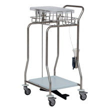 A stainless steel medical cart with four wheels, wire basket, flat shelf, lower shelf, handles, foot pedal, dispenser for disposable gloves, and a Novocal collector for foil tubing made of stainless steel attached to one side (1 piece).