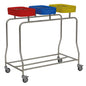The Novocal Triple Stainless Steel Laundry Collector "Compact" offers efficient laundry sorting thanks to three colored lids (red, blue, yellow). Four wheels enable mobility; the open frame design saves space and impresses with functionality.