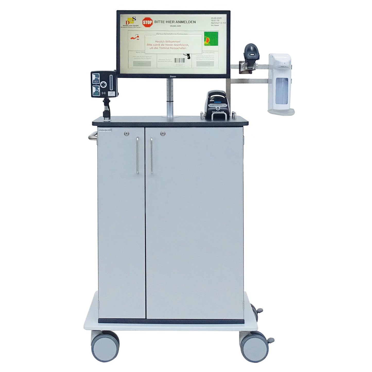 The Novocal Digital Reception Assistant with temperature measurement is a mobile medical workstation cart with a monitor, barcode scanner, hand sanitizer dispenser, printer, as well as visitor registration and two cabinet doors on four wheels.