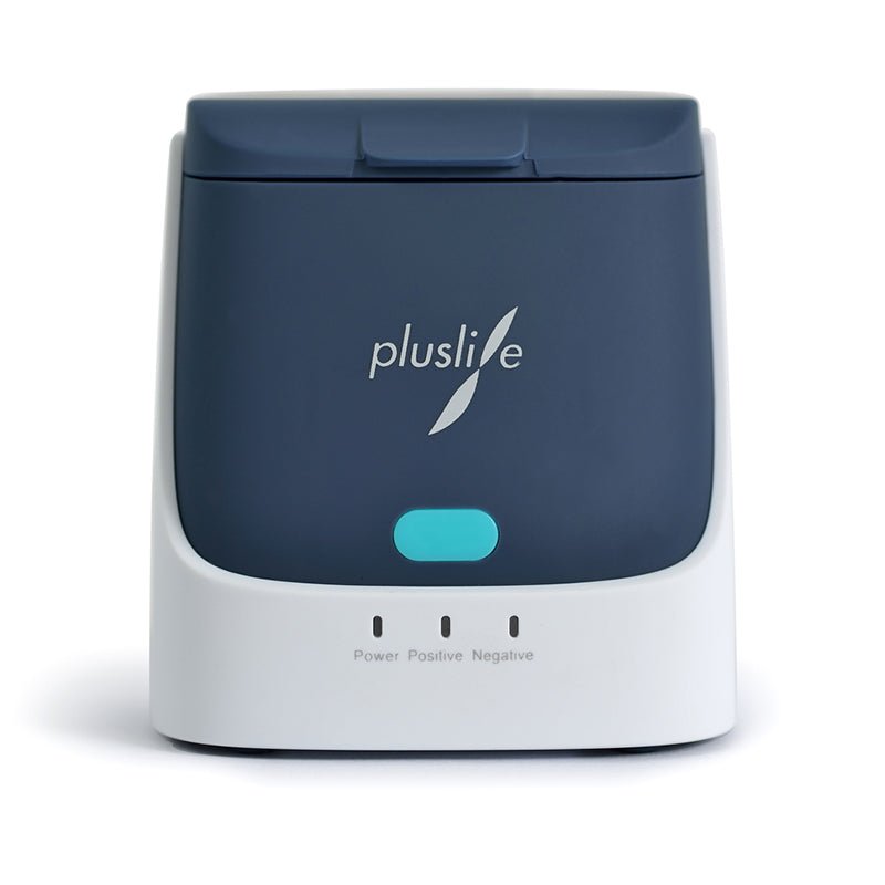 The Pluslife Mini Dock PoC-NAT testing device is a compact, dark gray and white electronic device with the "pluslife" logo. With its blue button and three control lights labeled "Power," "Positive," and "Negative," it provides laboratory-accurate test results for precise point-of-care testing.