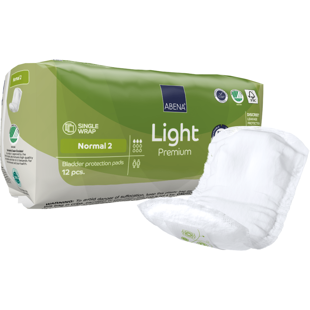 A green-white ABENA Light Normal 2, Premium | Pack (12 pieces) from Abena Re-Seller GmbH stands next to an unfolded insert. The packaging displays product details, symbols, and highlights absorbency.